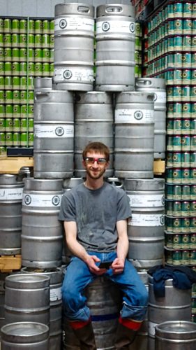 Our employee Geoffrey sitting on a throne made of kegs.
