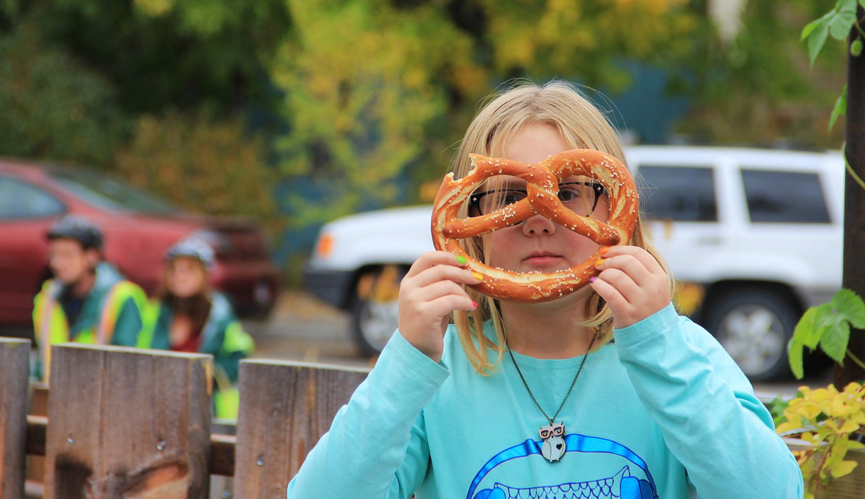 child outside with pretzel